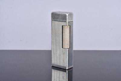 A 1950s silver plated pocket lighter, with engine turned panels, with British Patent number and US Patent RE24163, initials N.C to the top (1), no postal shipment for this lot
