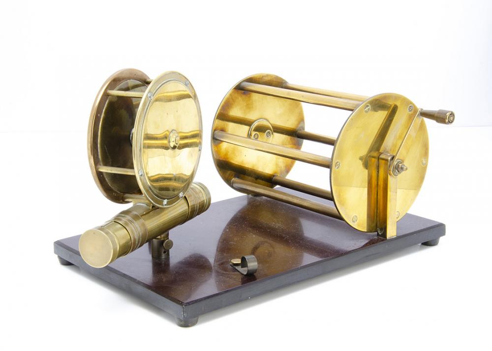 A vintage brass fishing reel mounted display, comprising of two
